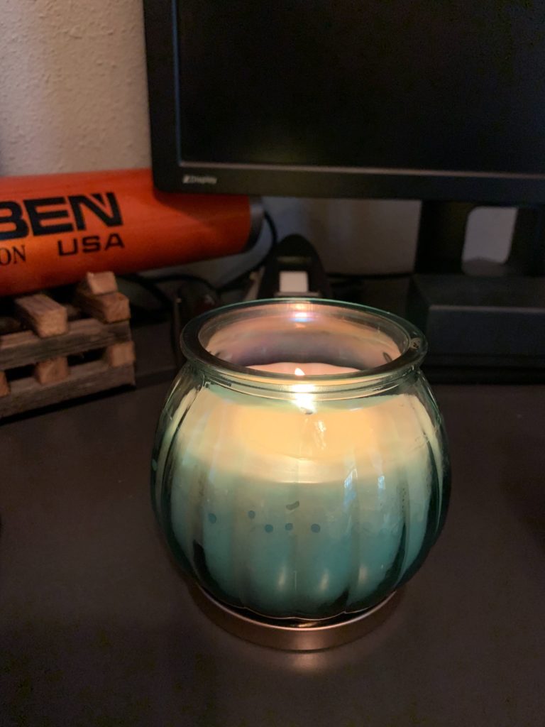 A candle on a desk